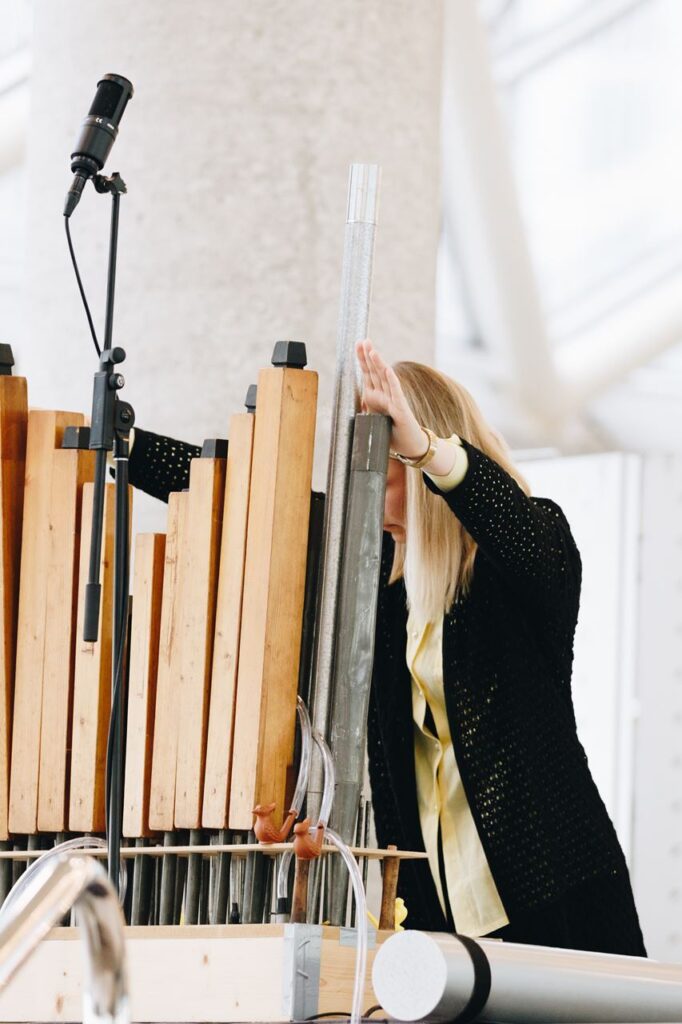 A woman adjusting an organ.