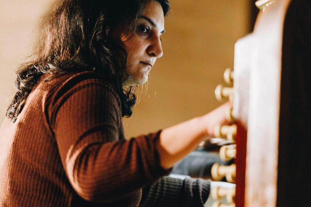 Close-up of a woman playing the organ.